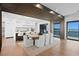 Elegant dining area with adjacent kitchen featuring hardwood floors, modern lighting, and seating for eight at 2087 Michigan Ne Ave, St Petersburg, FL 33703