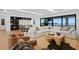 Large living area with a modular sofa, spiral staircase and floor-to-ceiling windows with a water view at 2087 Michigan Ne Ave, St Petersburg, FL 33703