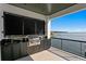 Outdoor kitchen with built-in grill and sink offering picturesque views of the water at 2087 Michigan Ne Ave, St Petersburg, FL 33703