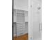 Custom walk-in closet featuring built-in shelving and a glass-enclosed shower at 2087 Michigan Ne Ave, St Petersburg, FL 33703