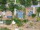 Aerial view displaying a house with a pool, green lawn, and surrounding residential area at 2202 Colewood Ln, Dover, FL 33527