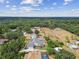 Aerial view showcases homes with pools, landscaped yards, and tree-lined streets at 2202 Colewood Ln, Dover, FL 33527