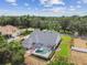Aerial view of backyard with pool and screened enclosure, perfect for outdoor living at 2202 Colewood Ln, Dover, FL 33527
