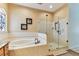Bathroom boasting a soaking tub and separate shower with glass enclosure at 2202 Colewood Ln, Dover, FL 33527