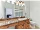 Bathroom vanity with granite countertop, framed mirror and views to the bedroom at 2202 Colewood Ln, Dover, FL 33527