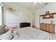 Bright bedroom with a large bed, a ceiling fan, and decoratively painted walls at 2202 Colewood Ln, Dover, FL 33527