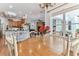 A sunlit dining area with hardwood floors that connects to a luxurious kitchen at 2202 Colewood Ln, Dover, FL 33527