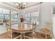 Sunny dining area with hardwood floors and views of the lanai at 2202 Colewood Ln, Dover, FL 33527