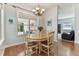 Bright dining room features hardwood floors, natural light and views into sunroom at 2202 Colewood Ln, Dover, FL 33527