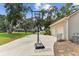 Long driveway with basketball hoop leading to a two-car garage, providing ample parking and space for recreation at 2202 Colewood Ln, Dover, FL 33527