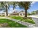 Inviting one-story home featuring a spacious front yard, a covered porch, and mature trees at 2202 Colewood Ln, Dover, FL 33527