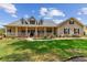 Beautiful home featuring a welcoming front porch, classic architectural details, and well-maintained landscaping at 2202 Colewood Ln, Dover, FL 33527