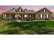 Charming single-Gathering home featuring a covered front porch, inviting curb appeal, and lush landscaping at 2202 Colewood Ln, Dover, FL 33527