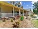 Charming front porch with classic design and beautiful landscaping create an inviting curb appeal at 2202 Colewood Ln, Dover, FL 33527