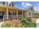 Charming front porch with classic design, white railings, and manicured landscaping at 2202 Colewood Ln, Dover, FL 33527