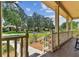View from the cozy front porch overlooking the well-manicured yard and quiet street at 2202 Colewood Ln, Dover, FL 33527