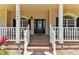 Inviting front porch featuring classic columns and railings, enhancing the home's curb appeal at 2202 Colewood Ln, Dover, FL 33527