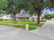 Inviting home with a spacious front yard, mature trees, and a charming front porch at 2202 Colewood Ln, Dover, FL 33527