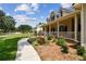 Beautiful landscaping accents this home's inviting front porch with a sidewalk leading to the house at 2202 Colewood Ln, Dover, FL 33527
