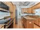 Open kitchen features wooden cabinets, granite countertops, stainless steel appliances, and center island at 2202 Colewood Ln, Dover, FL 33527
