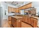 Spacious kitchen features wooden cabinets, granite countertops, stainless steel appliances, and center island at 2202 Colewood Ln, Dover, FL 33527