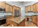 Spacious kitchen features wooden cabinets, granite countertops, stainless steel appliances, and center island at 2202 Colewood Ln, Dover, FL 33527