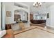 Bright living room offers tile flooring and opens to living room with fireplace and large sectional sofa at 2202 Colewood Ln, Dover, FL 33527