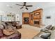The living room has a ceiling fan, a brick fireplace, and a comfortable, oversized brown leather sectional at 2202 Colewood Ln, Dover, FL 33527