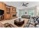 The living room features a brick fireplace, ceiling fan, and sliding glass doors leading to the pool area at 2202 Colewood Ln, Dover, FL 33527