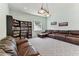 Spacious living room featuring plush seating and custom bookcase at 2202 Colewood Ln, Dover, FL 33527