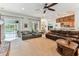 The living room offers a ceiling fan, hardwood floors, and a comfortable sectional sofa overlooking the pool at 2202 Colewood Ln, Dover, FL 33527