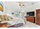A spacious bedroom with a large bed, tv, and access to the Primary bathroom at 2202 Colewood Ln, Dover, FL 33527
