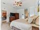 A peaceful main bedroom with neutral colors, ceiling fan and cozy furniture at 2202 Colewood Ln, Dover, FL 33527