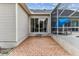 A brick patio leading to a screened-in pool area, offering a seamless transition between indoor and outdoor living at 2202 Colewood Ln, Dover, FL 33527