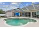 Inviting screened-in pool area with table and seating, ideal for outdoor enjoyment and entertaining at 2202 Colewood Ln, Dover, FL 33527