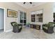 Cozy sunroom with tile flooring, wicker chairs, and large windows providing ample natural light at 2202 Colewood Ln, Dover, FL 33527