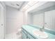 Bright bathroom featuring a clean white sink, toilet, and tile floors, with a large mirror over the vanity at 2456 Alhambra St, Clearwater, FL 33761