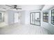 This bedroom features a sliding glass door to the outside and wood-look flooring at 2456 Alhambra St, Clearwater, FL 33761