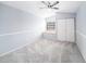 This bedroom is complete with new paint and carpet with a built-in benchseat under the window at 2456 Alhambra St, Clearwater, FL 33761
