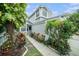A well-maintained townhome with lush landscaping leading to the front entrance at 2456 Alhambra St, Clearwater, FL 33761
