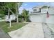 A row of townhomes is showcased, each featuring a private driveway and an American flag at 2456 Alhambra St, Clearwater, FL 33761