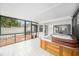A covered hot tub on a tile floor with access to an outdoor patio area with pavers and white fencing at 2456 Alhambra St, Clearwater, FL 33761