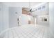 Bright living area with tiled floors, a ceiling fan, and a staircase leading to the second floor at 2456 Alhambra St, Clearwater, FL 33761