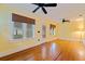 Bright living room with hardwood floors, ceiling fan, and natural light from multiple windows at 246 18Th Ne Ave, St Petersburg, FL 33704