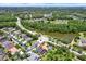 Beautiful home aerial showcasing the property, pool, and surrounding lush landscape in a desirable neighborhood at 2614 Brookforest Dr, Wesley Chapel, FL 33544