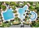 A stunning aerial view of the community pools including a slide, swimming lanes, a splash pad, and tropical landscaping at 2614 Brookforest Dr, Wesley Chapel, FL 33544