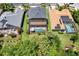 Aerial view of the home featuring a screened-in pool, lush lawn, and proximity to trees and landscaping at 2614 Brookforest Dr, Wesley Chapel, FL 33544