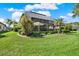 Expansive backyard featuring a screened-in patio and an outdoor space, landscaped for privacy and relaxation at 2614 Brookforest Dr, Wesley Chapel, FL 33544