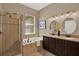 Bathroom featuring a soaking tub, walk-in shower, and double vanity at 2614 Brookforest Dr, Wesley Chapel, FL 33544