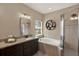 Bright bathroom featuring granite counters, soaking tub, and glass-enclosed shower at 2614 Brookforest Dr, Wesley Chapel, FL 33544